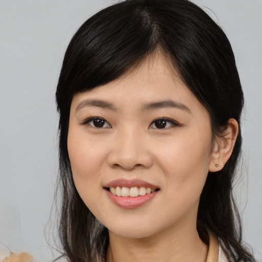 Joyful asian young-adult female with medium  black hair and brown eyes