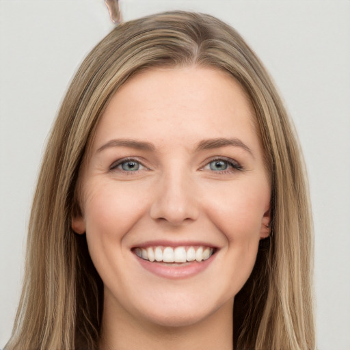 Joyful white young-adult female with long  brown hair and grey eyes