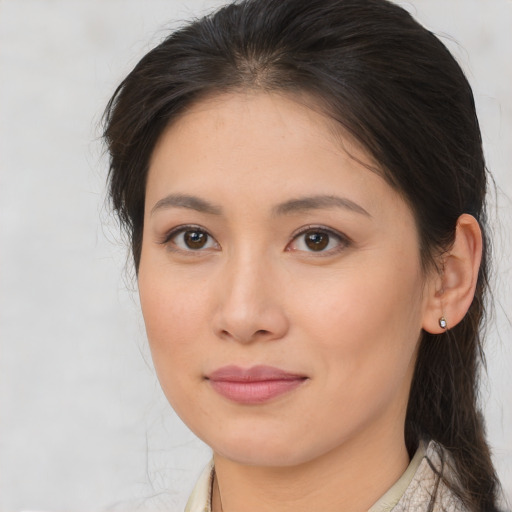 Joyful asian young-adult female with medium  brown hair and brown eyes