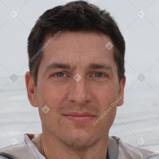 Joyful white adult male with short  brown hair and brown eyes