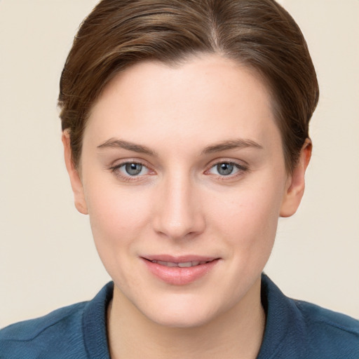 Joyful white young-adult female with short  brown hair and grey eyes