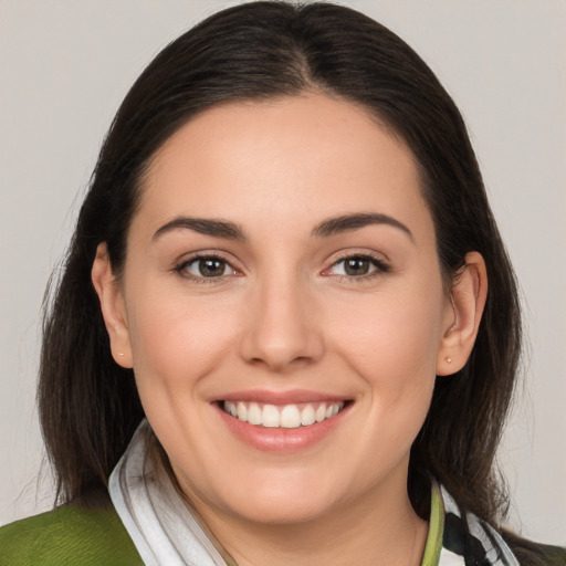 Joyful white young-adult female with medium  brown hair and brown eyes