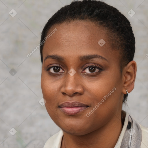 Joyful black young-adult female with short  brown hair and brown eyes