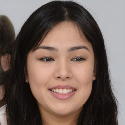 Joyful asian young-adult female with long  brown hair and brown eyes