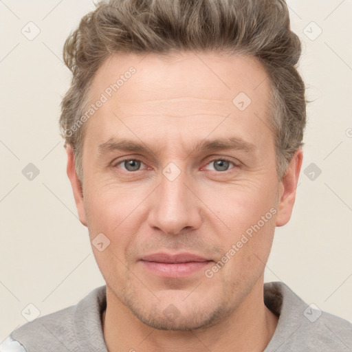 Joyful white adult male with short  brown hair and grey eyes