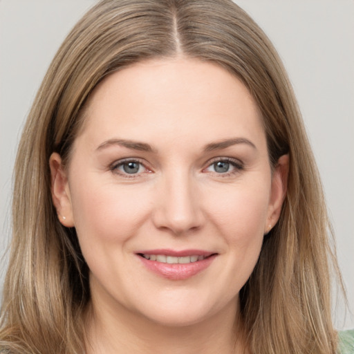 Joyful white young-adult female with long  brown hair and grey eyes