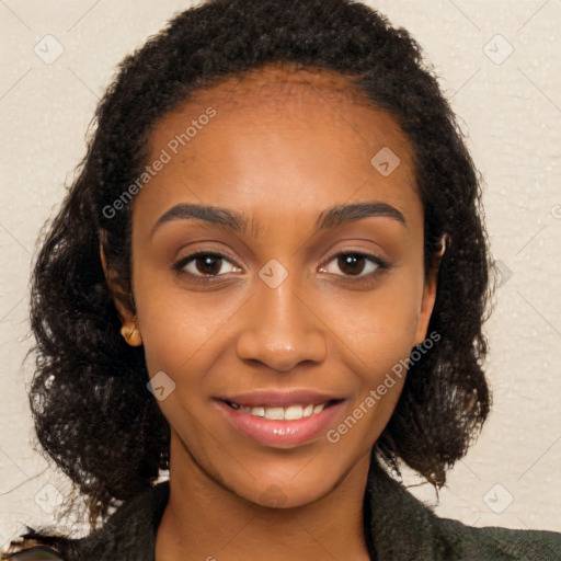 Joyful black young-adult female with long  brown hair and brown eyes