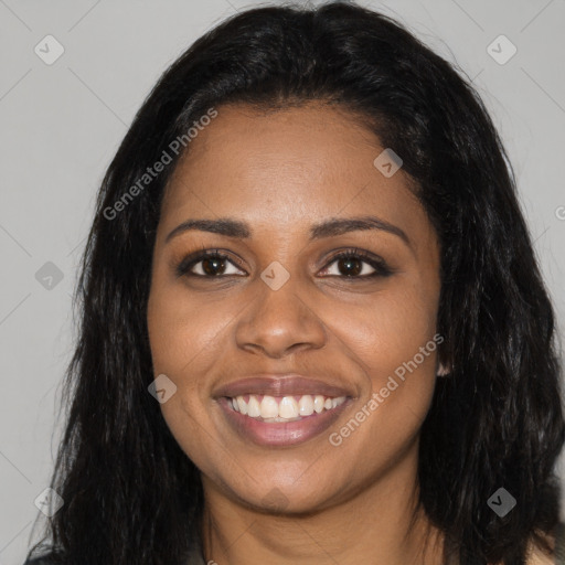 Joyful black young-adult female with long  black hair and brown eyes