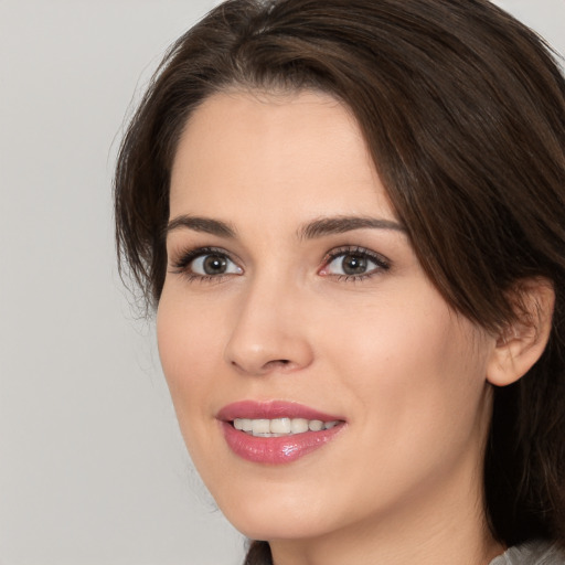 Joyful white young-adult female with medium  brown hair and brown eyes