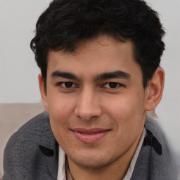 Joyful latino young-adult male with short  brown hair and brown eyes