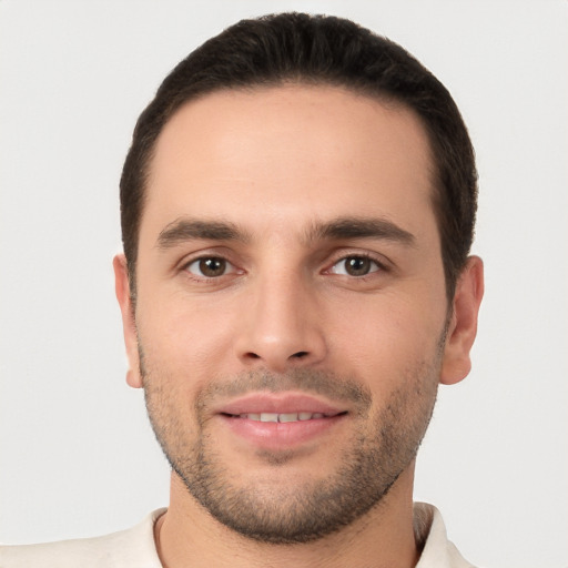 Joyful white young-adult male with short  brown hair and brown eyes