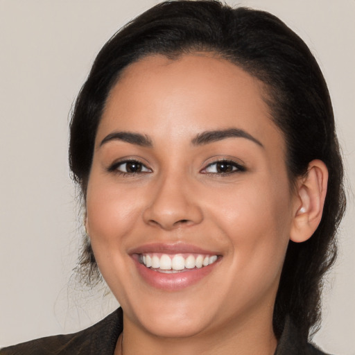 Joyful latino young-adult female with long  brown hair and brown eyes