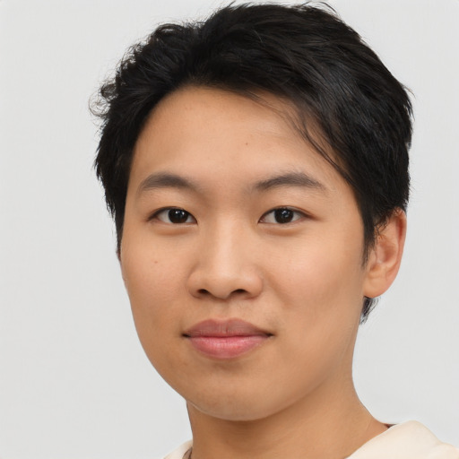 Joyful asian young-adult female with short  black hair and brown eyes