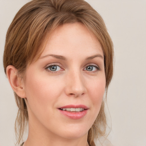 Joyful white young-adult female with medium  brown hair and blue eyes