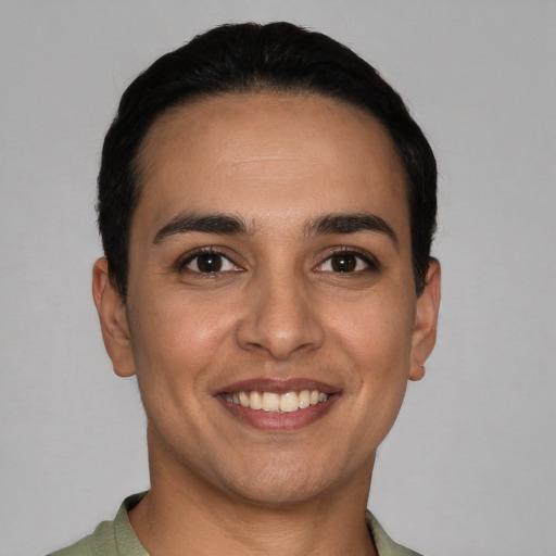 Joyful white young-adult male with short  black hair and brown eyes