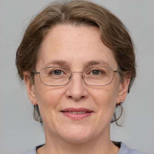 Joyful white middle-aged female with medium  brown hair and blue eyes