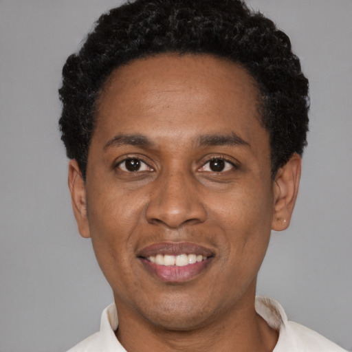 Joyful latino adult male with short  black hair and brown eyes