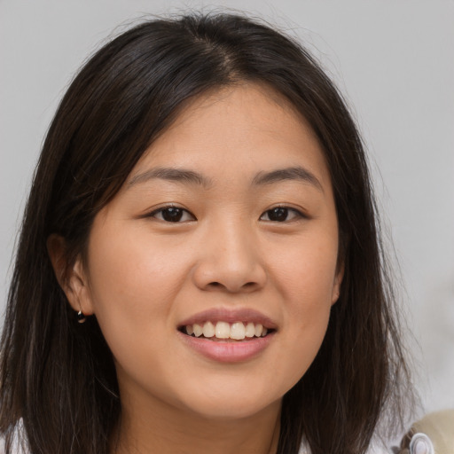 Joyful white young-adult female with long  brown hair and brown eyes