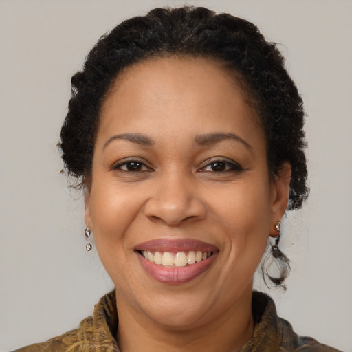 Joyful black adult female with short  brown hair and brown eyes