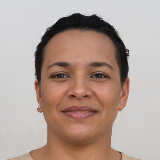 Joyful latino young-adult female with short  black hair and brown eyes