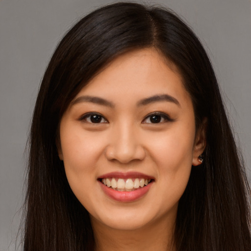 Joyful latino young-adult female with long  brown hair and brown eyes