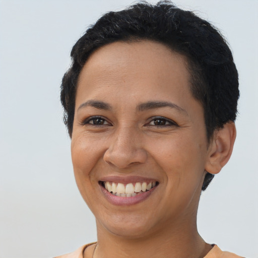 Joyful latino young-adult female with short  brown hair and brown eyes
