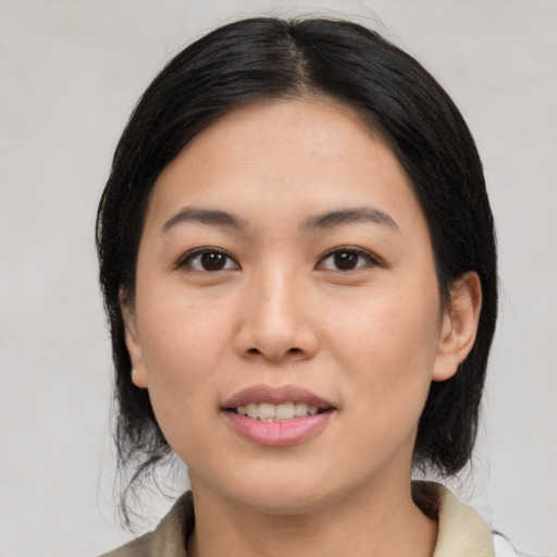 Joyful latino young-adult female with medium  black hair and brown eyes