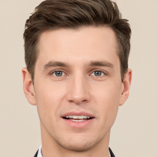 Joyful white young-adult male with short  brown hair and grey eyes