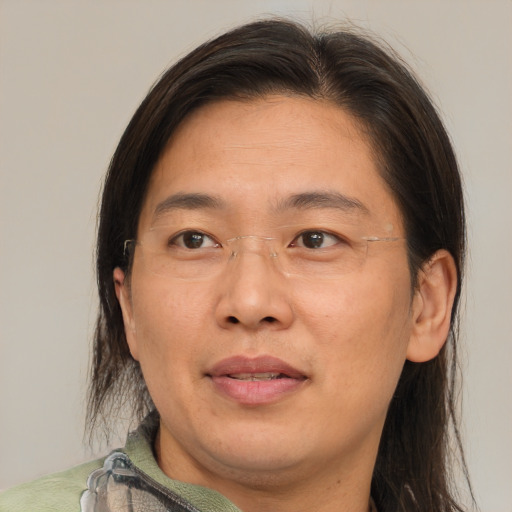 Joyful asian adult male with medium  brown hair and brown eyes