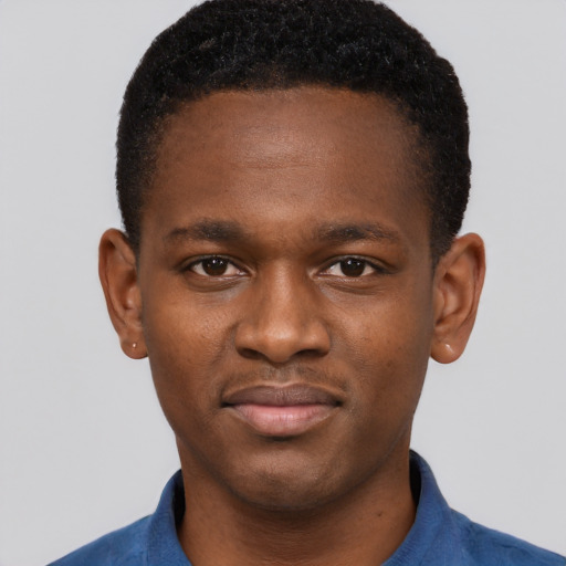Joyful black young-adult male with short  brown hair and brown eyes
