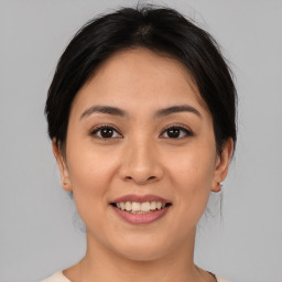 Joyful asian young-adult female with medium  brown hair and brown eyes