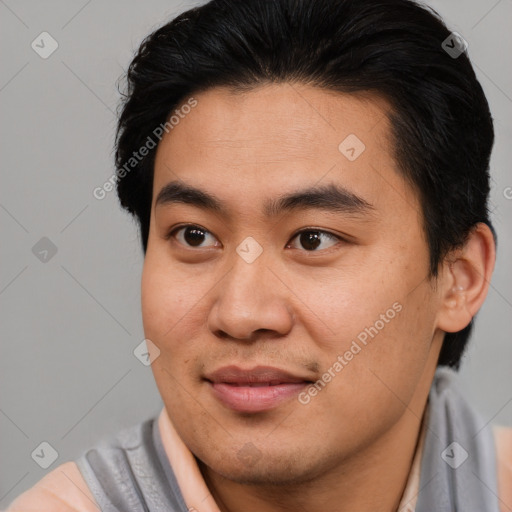 Joyful asian young-adult male with short  brown hair and brown eyes