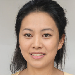 Joyful asian young-adult female with medium  brown hair and brown eyes