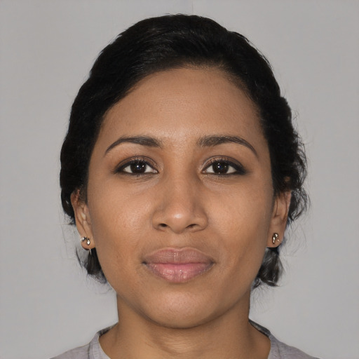Joyful black young-adult female with medium  black hair and brown eyes