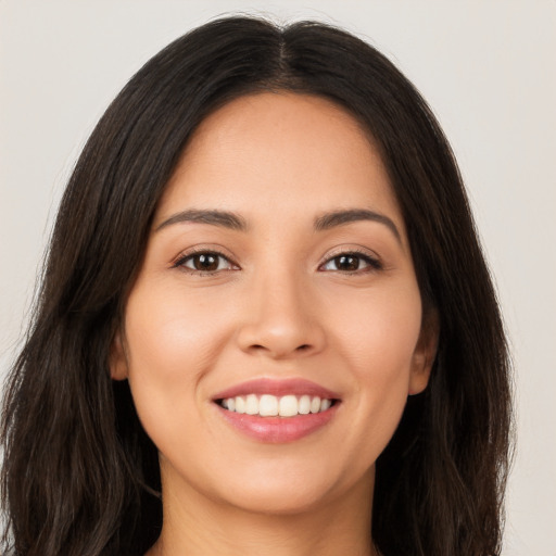 Joyful white young-adult female with long  brown hair and brown eyes