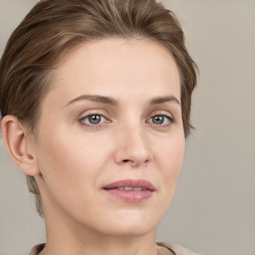 Joyful white young-adult female with short  brown hair and grey eyes