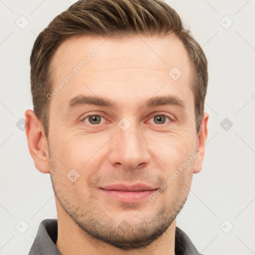 Joyful white young-adult male with short  brown hair and grey eyes