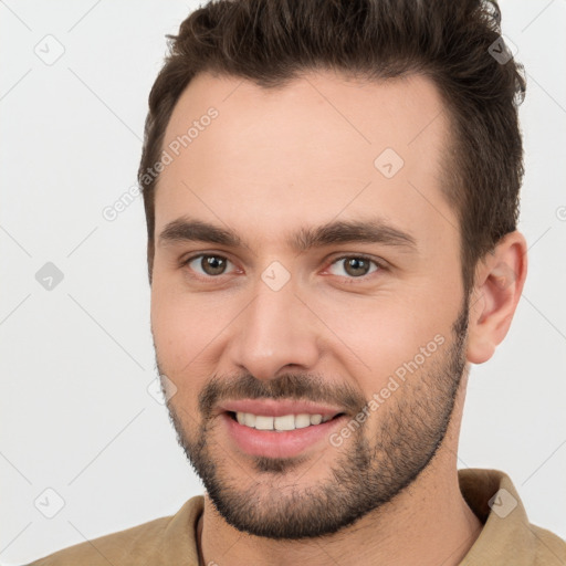 Joyful white young-adult male with short  brown hair and brown eyes