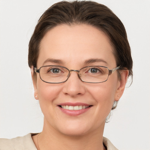 Joyful white adult female with medium  brown hair and grey eyes