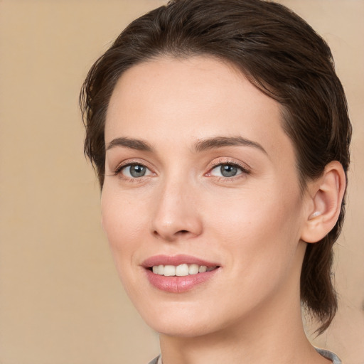 Joyful white young-adult female with medium  brown hair and brown eyes