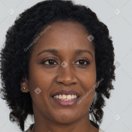 Joyful black young-adult female with long  brown hair and brown eyes