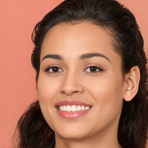 Joyful white young-adult female with long  brown hair and brown eyes