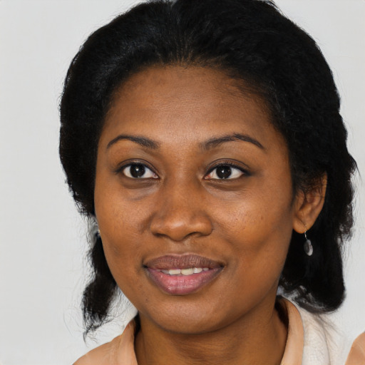 Joyful black young-adult female with medium  black hair and brown eyes