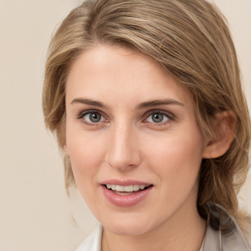 Joyful white young-adult female with medium  brown hair and grey eyes