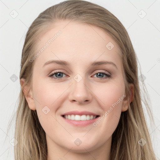 Joyful white young-adult female with long  brown hair and grey eyes