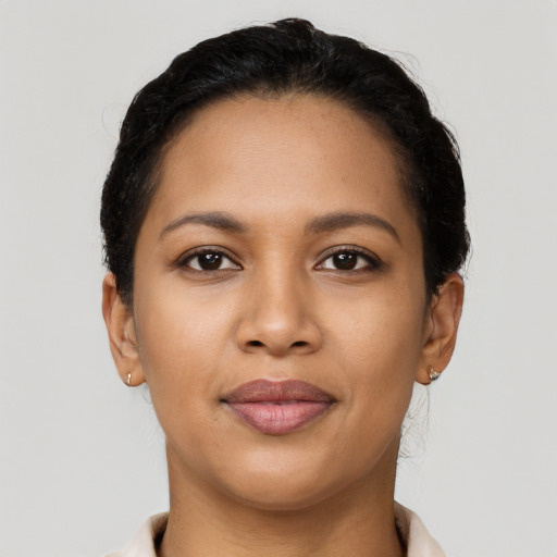 Joyful latino young-adult female with short  brown hair and brown eyes