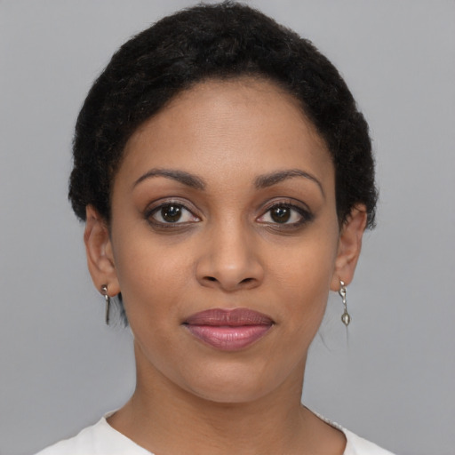 Joyful latino young-adult female with short  black hair and brown eyes