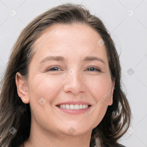 Joyful white adult female with long  brown hair and grey eyes