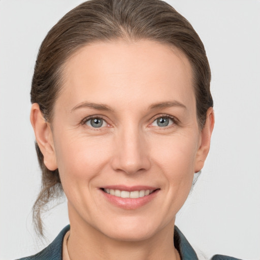 Joyful white adult female with medium  brown hair and grey eyes