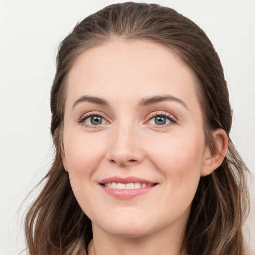 Joyful white young-adult female with long  brown hair and grey eyes